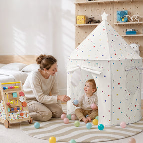 A woman kneels beside a child playing inside a white Tiny Land® Kids Tent – Indoor Tent for Toddlers decorated with colorful dots and filled with plastic balls.|Colorful Dots