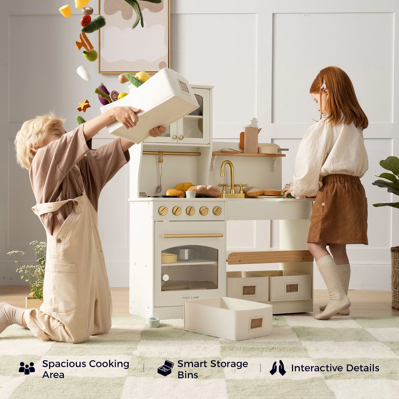 Two children play with the Tiny Land® Wooden Play Kitchen with Storage for Creative Toddlers, tossing pretend cookware and play food in the air. Wooden kitchen accessories and storage bins from Tiny Land are visible, along with icons that read “Spacious Cooking Area,” “Smart Storage Bins,” and “Interactive Details.” This storage play kitchen from Tiny Land offers plenty of room for imaginative fun.|cream