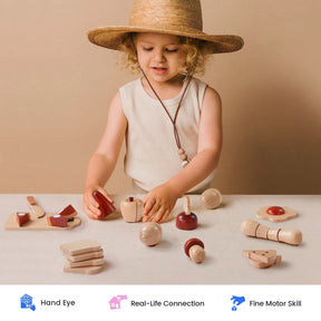 A young child wearing a straw hat plays at a table with the Tiny Land® Play Kitchen Accessories – Play Food for Play Kitchen: Wooden Cut and Play Food Toys by Tiny Land Play Food. Icons below highlight benefits such as hand-eye coordination, real-life connection, and fine motor skill development.