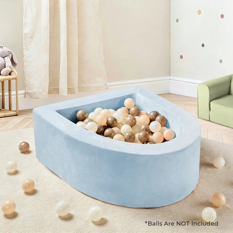 A Tiny Land® PlayNest Soft Foam Ball Pit – Balls Not Included, in light blue, is nestled in a cozy kids’ room with pastel decor. Beige, brown, and white balls fill the pit and are scattered on the floor, inviting hours of sensory play. Text at the bottom reads: *Balls Are NOT Included.|Blue