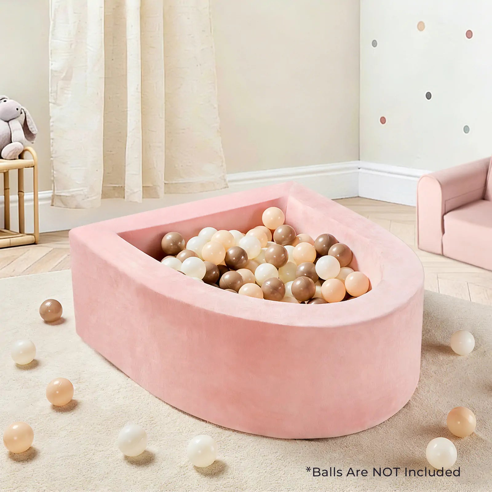 A Tiny Land® PlayNest Ball Pit (Ocean Balls Not Included) by Tiny Land, pink and teardrop-shaped, sits in a kids’ room with pastel and neutral décor, plush bunny, beige curtains, and pastel polka dots. Balls are NOT included.|pink