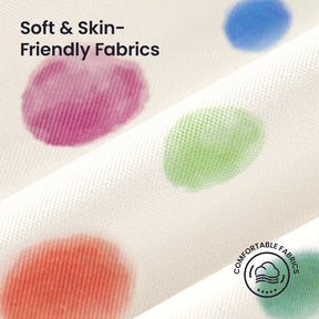 Close-up of Tiny Land® Adventure Play Tunnel's white fabric with large colorful polka dots in purple, green, blue, and orange. Text: Soft & Skin-Friendly Fabrics and Comfortable Fabrics with a cloud icon. Brand: Tiny Land.