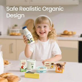 A young girl smiles in a kitchen, holding the Tiny Land® Organic Dairy Pack. Realistic pretend foods like apple juice, cheese, butter, and honey sit in front of her. Safe organic design—perfect for any Tiny Land wooden kitchen toys collection.