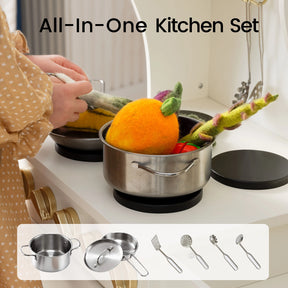 A child places colorful felt vegetables into a small metal pot on a play kitchen stove. Text reads Tiny Land® Wooden Play Kitchen with Storage for Creative Toddlers. This pretend cookware set by Tiny Land features images of a pot, lid, and various utensils on a white background—perfect for any storage play kitchen.|cream