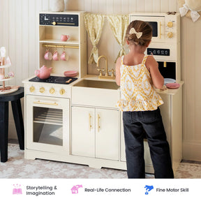 A young child enjoys imaginative play with the Tiny Land® Iconic Wooden Play Kitchen – Cream Pretend Cooking Set for Kids, pretending to cook alongside pink tea sets and utensils. Icons below showcase benefits such as storytelling, real-life connection, and fine motor skill development.