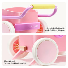 A close-up of the Tiny Land® 3-in-1 Wooden Baby Walker Wagon in pink, featuring a yellow and pink handle, anti-collision silicone on the handle, silent wheels with backheel support, and the Tiny Land logo.
