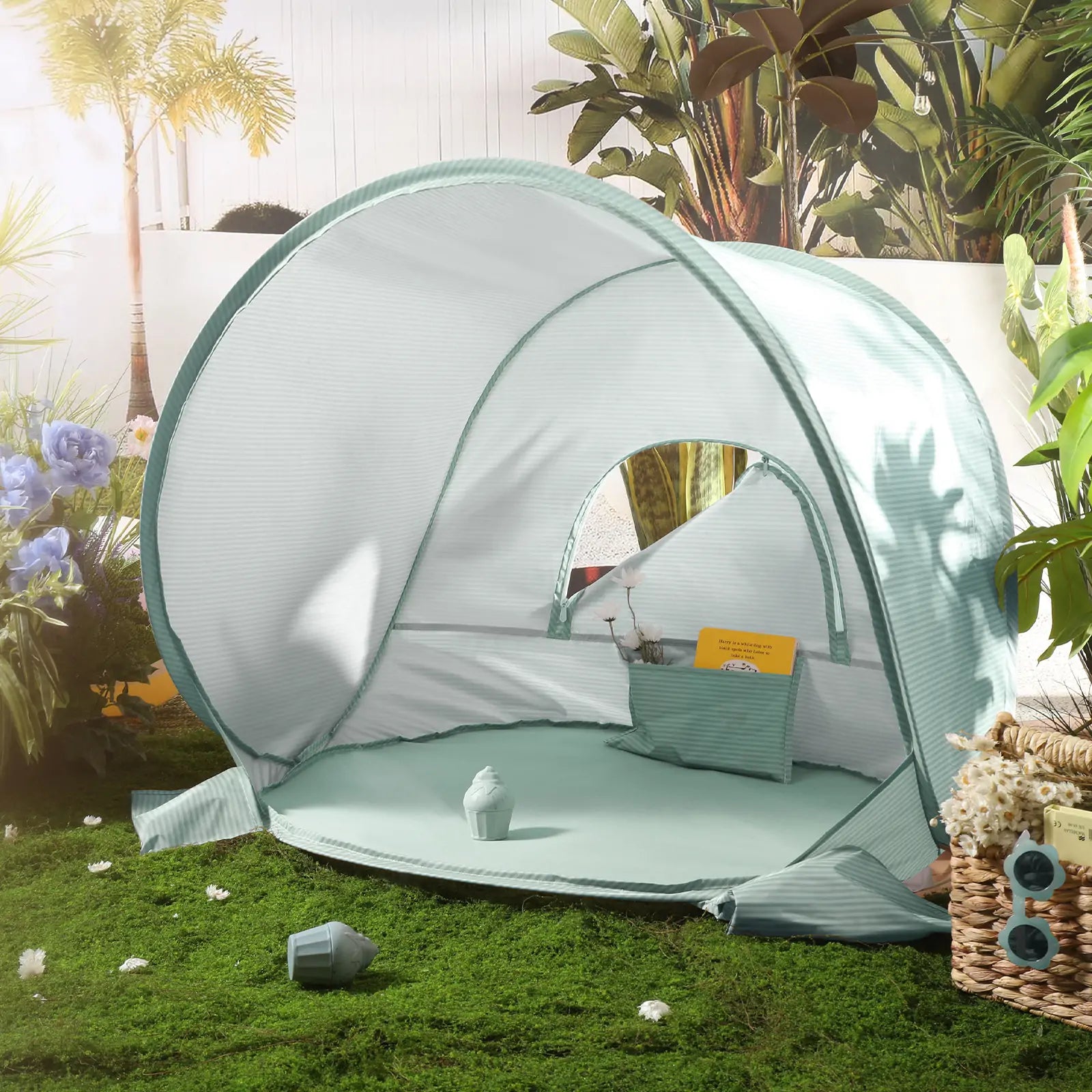 The Tiny Land® One-Stop Beach Toy & Tent Set in Sea Blue offers UV protection and a cozy interior, perfect for outdoor retreats. Surrounded by plants and flowers, it creates a sunny space for relaxation on the grass.