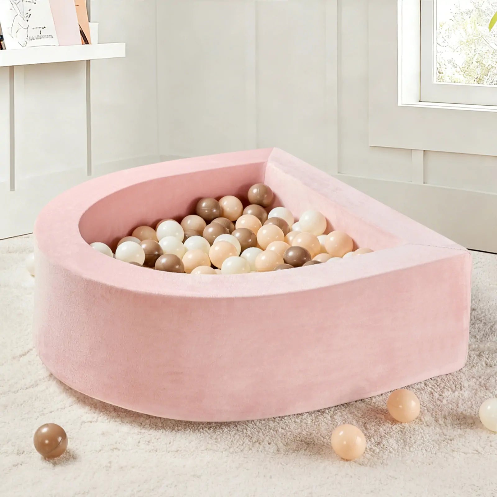 The Tiny Land® Violet PlayNest Climbing & Ball Pit Set by Tiny Land, filled with beige, brown, and white balls, sits atop a cream-colored rug—perfect for sensory play.|Pink
