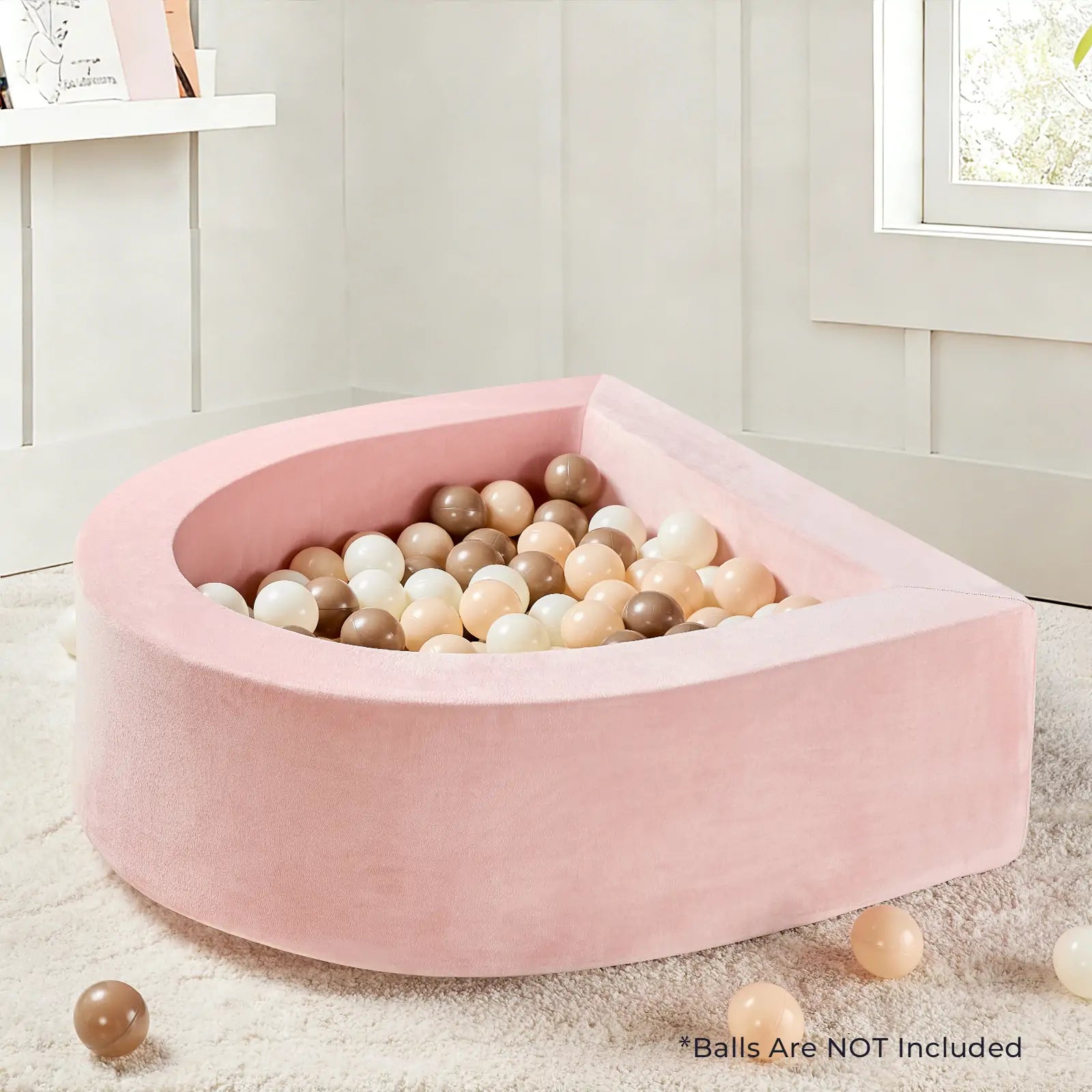 A Tiny Land® PlayNest Ball Pit - Ocean Ball Not Included by Tiny Land sits on a beige carpet, filled with pastel balls and some scattered outside. Text reads: Balls are NOT included.|pink