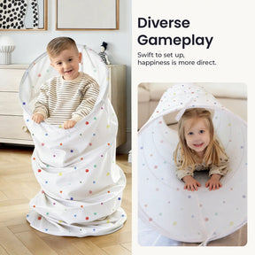 Two children smile as they play with the Tiny Land® Adventure Play Tunnel - Colorful Polka Dots. The boy stands inside, while the girl crawls through the tunnel. Text overlay: Diverse Gameplay. Brand: Tiny Land.|white