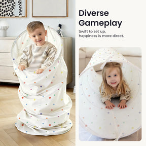 A young boy stands inside the Tiny Land® Adventure Play Tunnel - Colorful Polka Dots while a girl crawls through it. The text reads: Diverse Gameplay. Easy setup from Tiny Land means happiness comes fast.