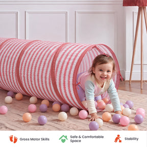 A toddler crawls out of a pink and white striped Tiny Land® Adventure Play Tunnel surrounded by colorful plastic balls, with icons below for Gross Motor Skills, Safe & Comfortable Space, and Stability.|Pink