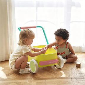 Two toddlers play with a colorful Tiny Land® 3-in-1 Wooden Baby Walker Wagon - Pink & Spring Color on a wood floor.|Spring Color