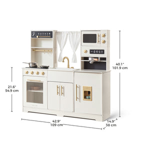 The Tiny Land® Play Kitchen with Running Water – Iconic Aqua Kitchen in Cream features a stove, oven, real water sink, microwave, shelves, and window with white curtains. Size: 40.1H x 42.9W x 14.9D in (101.9 x 109 x 38 cm).