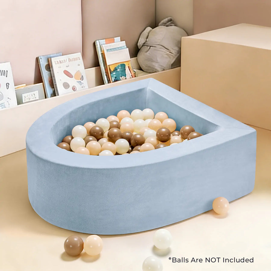 The Tiny Land® PlayNest Soft Foam Ball Pit by Tiny Land is a soft, light blue foam ball pit designed for sensory play (balls not included). Shown placed in a children's reading corner with books and plush toys—perfect for cozy playtime. *Balls Are NOT Included.|Blue
