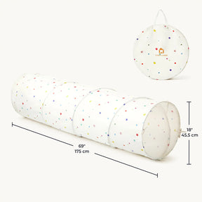 The Tiny Land® Adventure Play Tunnel by Tiny Land features colorful polka dots, measures 69" long and 18" in diameter, and folds neatly into a round carrying case with handle—ideal as an indoor or outdoor kids crawl tunnel for endless fun.
