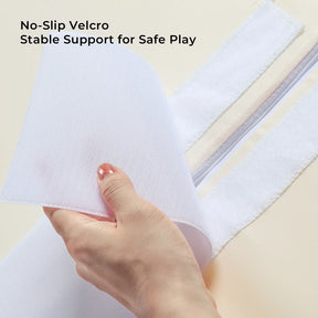A hand peels back white Velcro on Tiny Land® PlayNest Climbing Blocks, revealing the gripping side. Text above: No-Slip Velcro. Stable Support for Safe Play. The background is a light, neutral color. Brand: Tiny Land.