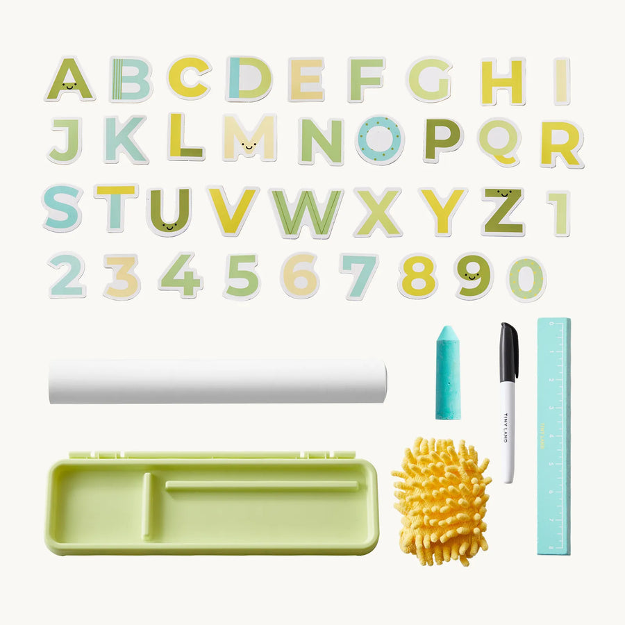 Alphabet and number puzzle pieces, a rolled sheet, turquoise chalk, black marker, blue ruler, yellow eraser, and a green storage case are arranged neatly on a white background—perfect for enhancing any art station or pairing with the Tiny Land® Double-Sided Magnetic Tabletop Easel by Tiny Land.|Green