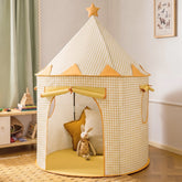 Tiny Land® Kids Tent in yellow and white checkered print with a star topper and an open entrance revealing a cozy reading nook with plush toys and cushions inside.|Yellow
