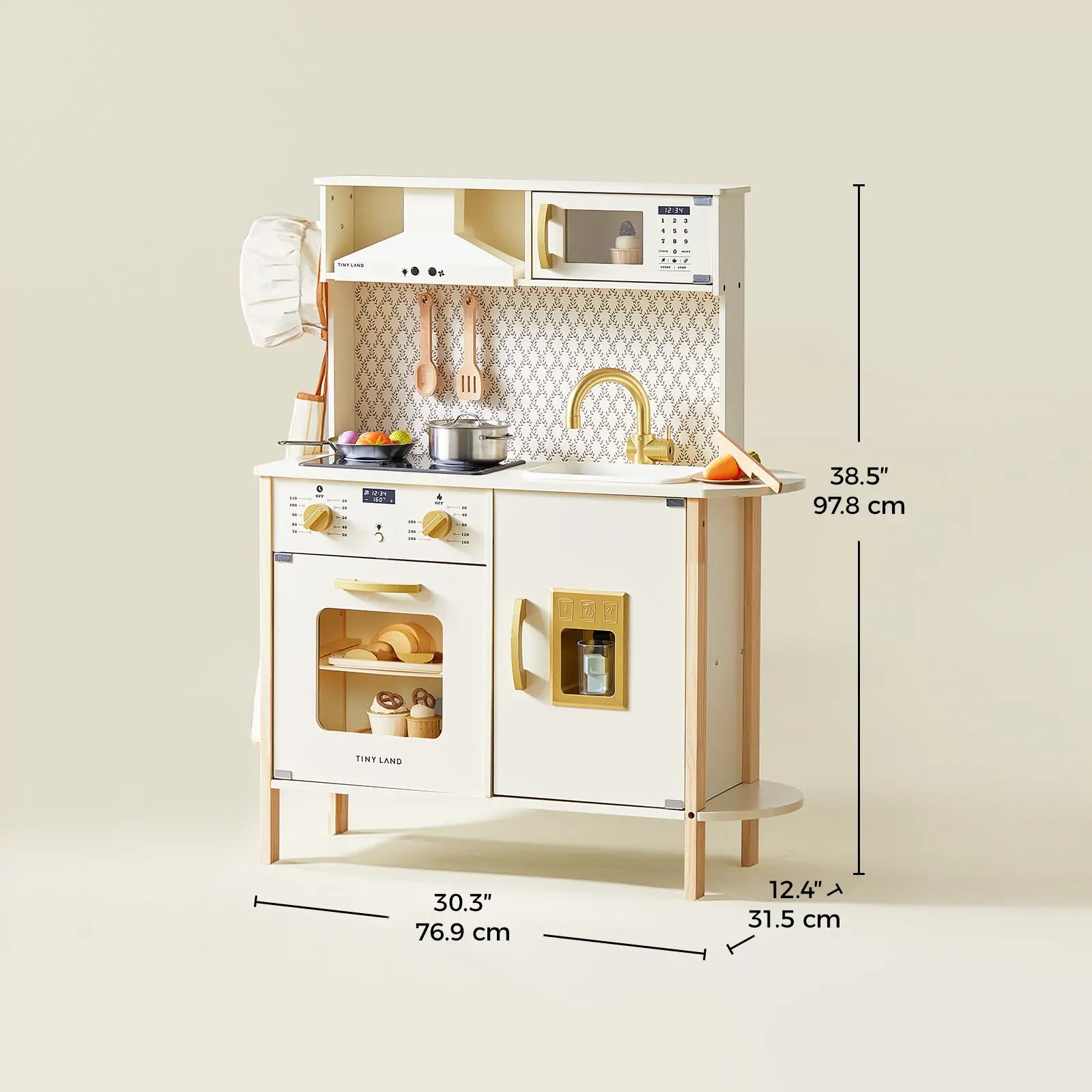 The Tiny Land® PopJoy Play Kitchen by Tiny Land is a stylish cream and gold kids' set with a stove, oven, sink, faucet, microwave, utensils, and chef hat. Sized 38.5" H x 30.3" W x 12.4" D—perfect for pretend play!.