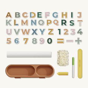 The Tiny Land® Double-Sided Magnetic Tabletop Easel - Yellow includes colorful magnetic letters, numbers, math symbols, a brown tray, chalk, eraser, pen, and yellow magnetic ruler—perfect for creative kids.