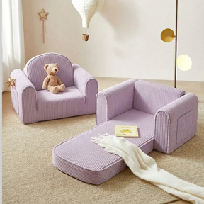 Two Tiny Land® GentleSnug Kid Chairs in purple are shown: one upright with a teddy bear, the other unfolded into a 2-in-1 kids sofa bed with a book and white blanket, set in a softly decorated neutral room.