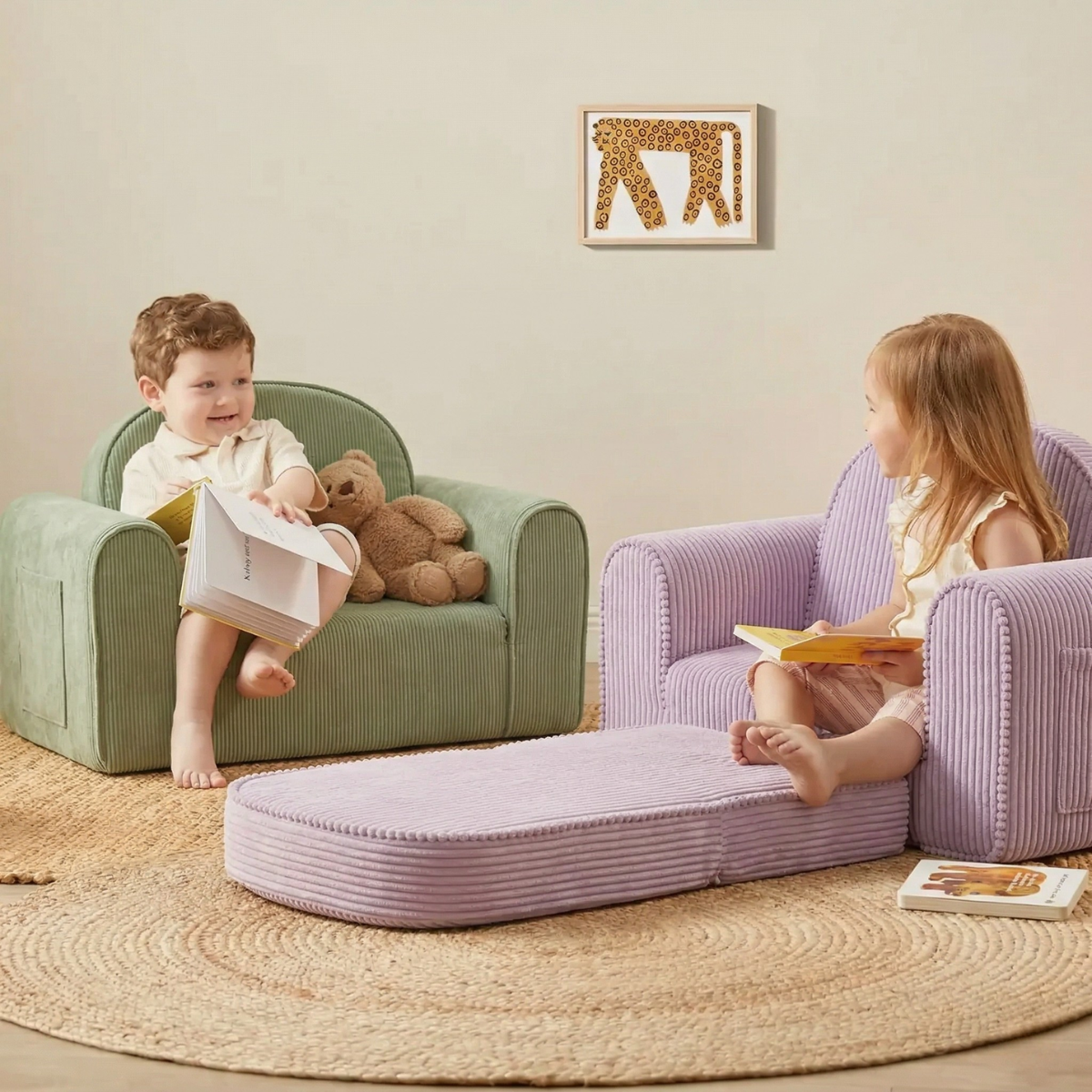 Two young children read books on Tiny Land® GentleSnug Kid Chairs in purple, surrounded by cozy decor. A teddy bear sits beside the boy, and an animal-themed artwork hangs on the wall behind them.