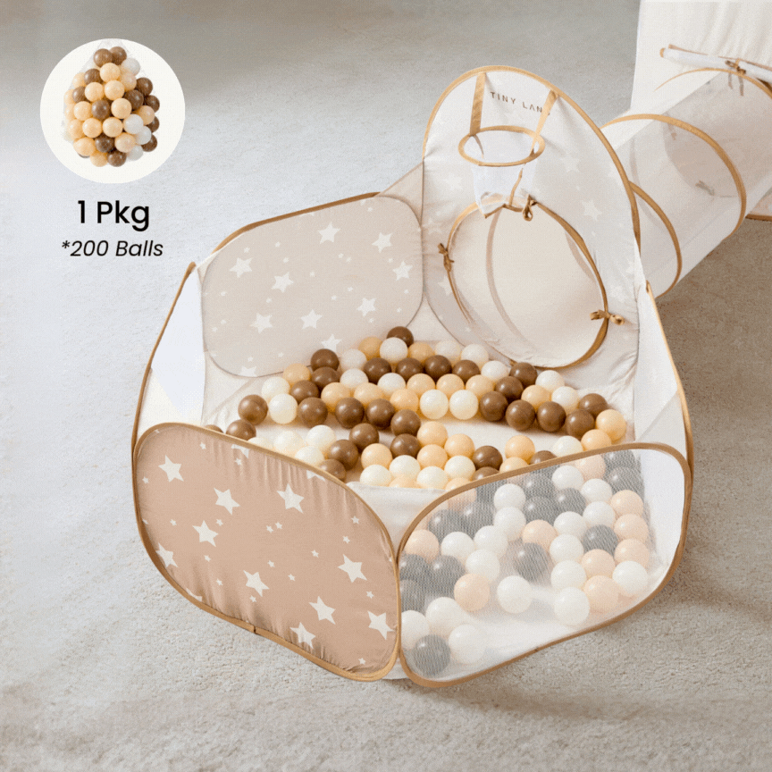 A Tiny Land playpen with a star pattern sits on a carpet, filled with 200 Tiny Land® Ocean Balls in beige, white, brown, and gray. A tunnel extends from the side; an inset shows a close-up of the multicolored balls.