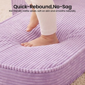 A child’s foot presses into the plush, purple ribbed velvet cushion of the Tiny Land® GentleSnug Corduroy Kid Chair, instantly springing back to showcase its no-sag and quick-rebound features. Text above emphasizes its superior softness and kid-friendly design, making it an ideal addition to any children’s lounge or Tiny Land corduroy furniture collection.|Purple