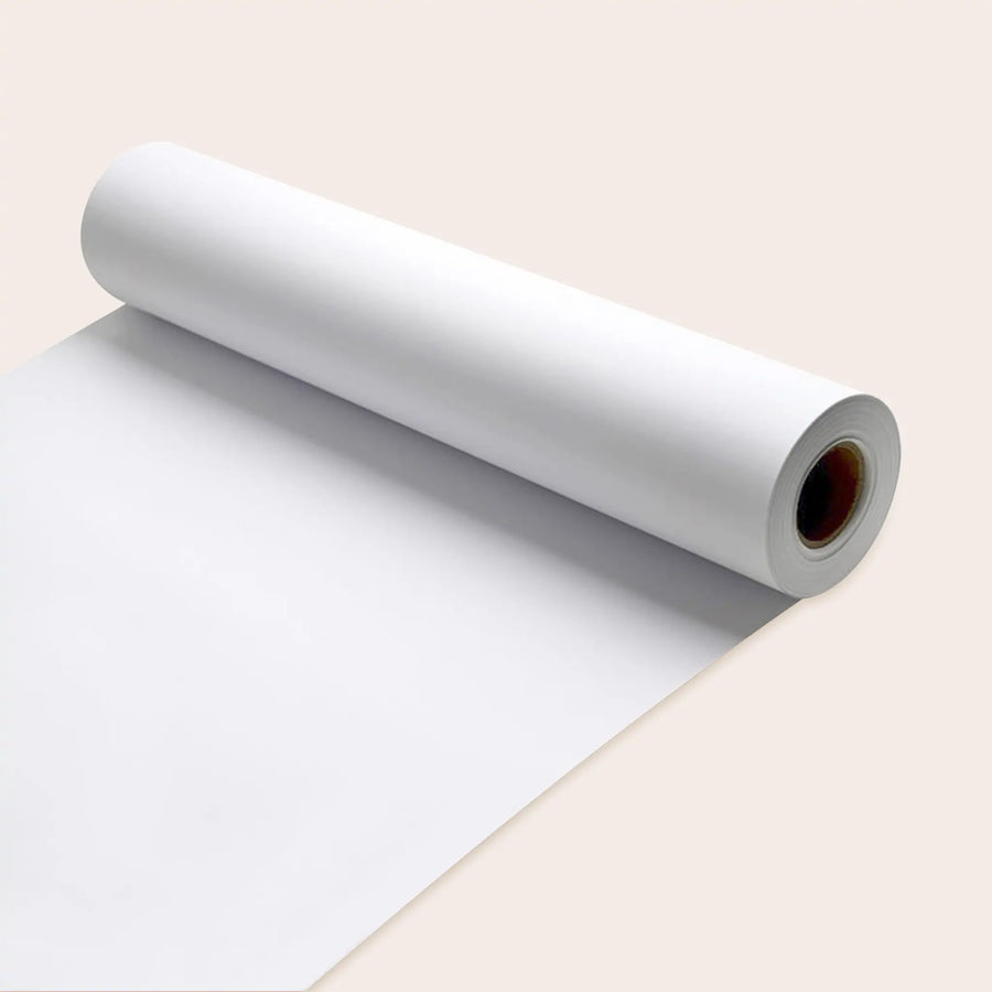 Three rolls of Tiny Land® Easel Paper Roll by Tiny Land, premium quality art paper, partially unrolled on a light beige background.