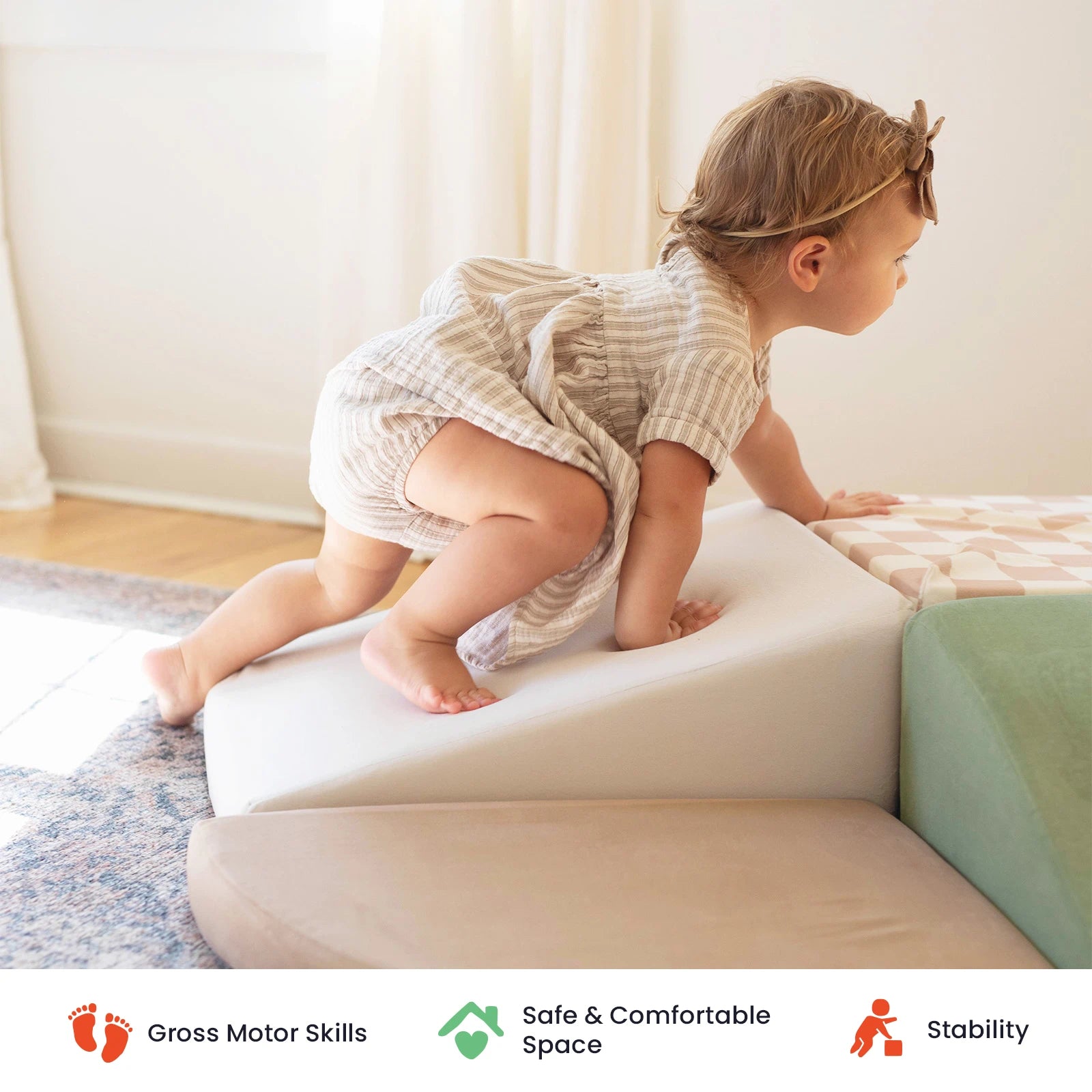 A young child climbs a soft foam ramp in a bright room, part of the inviting Tiny Land® PlayNest Climbing & Ball Pit Set by Tiny Land. Icons below highlight gross motor skill development, a safe play space, and enhanced stability.|Pink