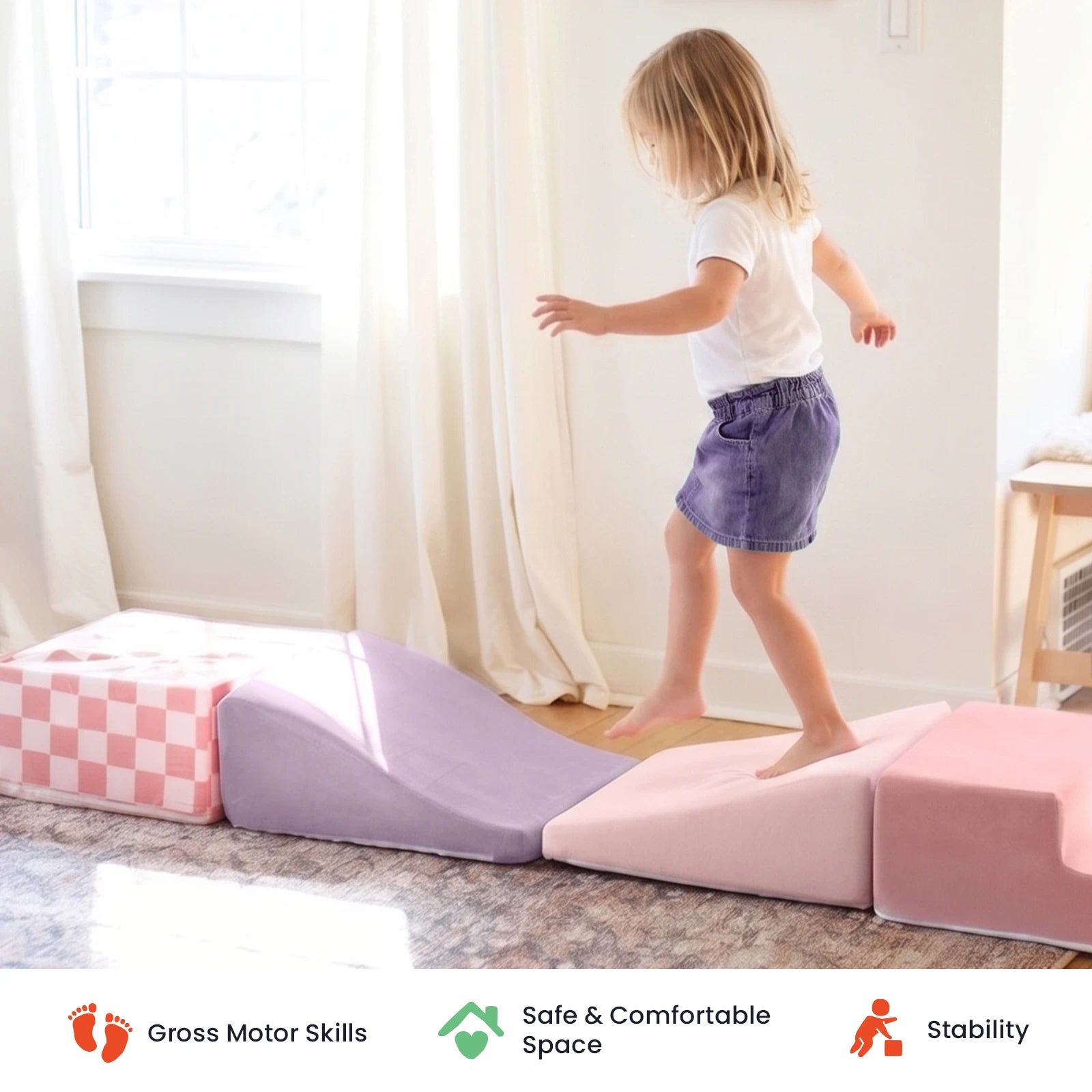 A young child walks barefoot on the Tiny Land® Violet PlayNest Climbing & Ball Pit Set in a sunlit room, practicing balance. Icons below highlight gross motor development, a safe and comfortable environment, and lasting stability—making this Tiny Land set perfect for sensory play.|Blue