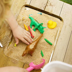 Sensory sand play with toy dinosaurs on Tiny Land® DuoPlay Mud Kitchen surface