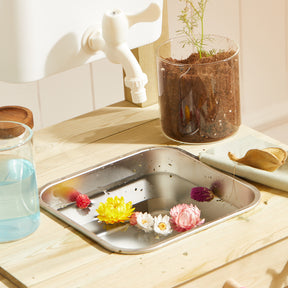 Close-up of water play sink with floating flowers on Tiny Land® DuoPlay Mud Kitchen