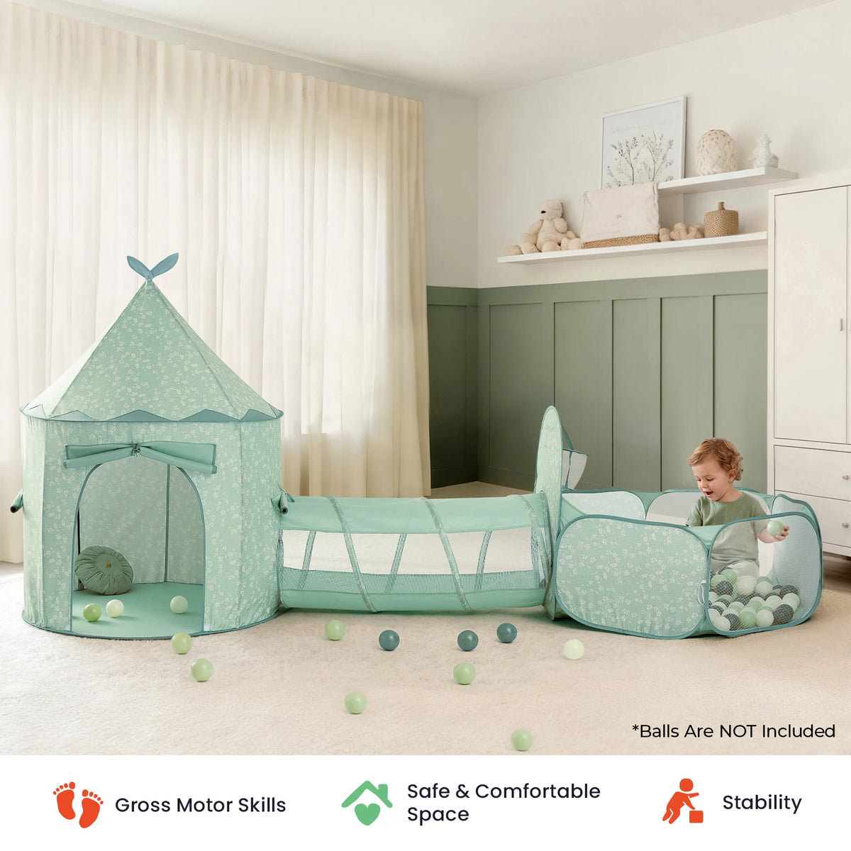 A young child plays with colorful balls inside the Tiny Land® Green Adventure 3-in-1 Play Tunnel & Fun-Shapes Ocean Ball Set by Tiny Land in a softly lit room. Icons below showcase its support for gross motor skills, sensory play, safety, comfort, and stability.