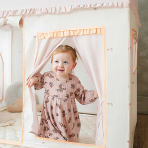 A toddler peeking through the curtained entrance of a Tiny Land® Cozy Nook – Playhouse Tent & GentleSnug Kid Chair.|Pink