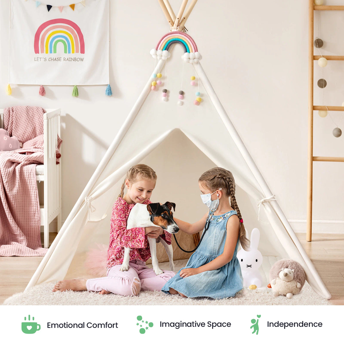 Two young girls sit in the Tiny Land® Teepee Tent for Kids with Mat by Tiny Land, one cradling a small dog. The room glows with rainbow decor and plush stuffed animals. Icons showcase emotional comfort, imaginative play, and independence—making this indoor play tent with floor mat the perfect cozy retreat to inspire creativity and joyful moments for children.