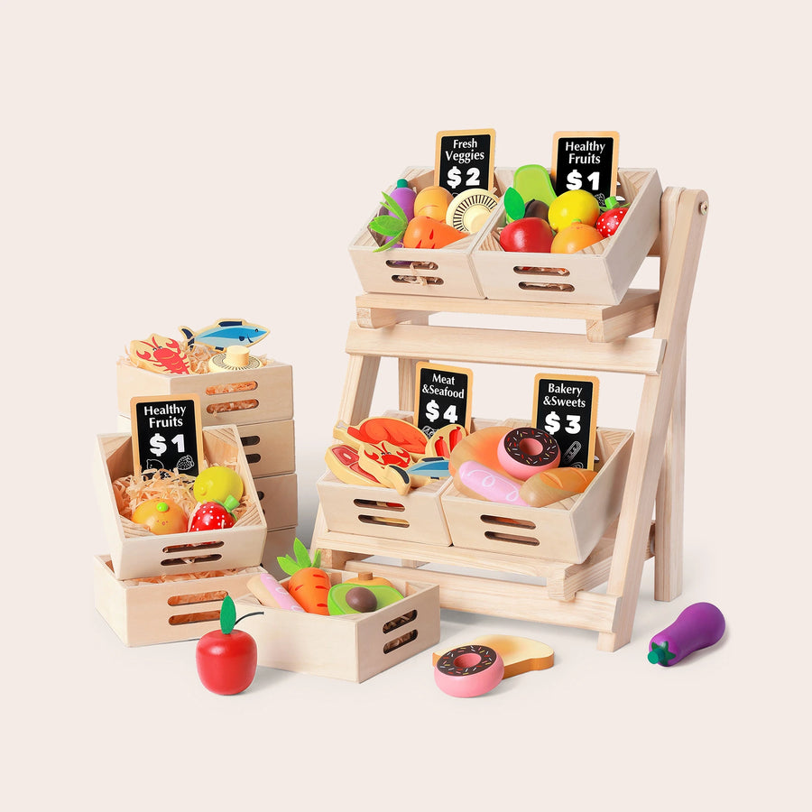 The Tiny Land® Wooden Food for Play Kitchen & Wooden Rack by Tiny Land Play Food features a market stand with small crates of colorful play food—fruits, veggies, seafood, and baked goods—plus mini chalkboard price signs and the Tinyland wooden cutting fruit toy set.