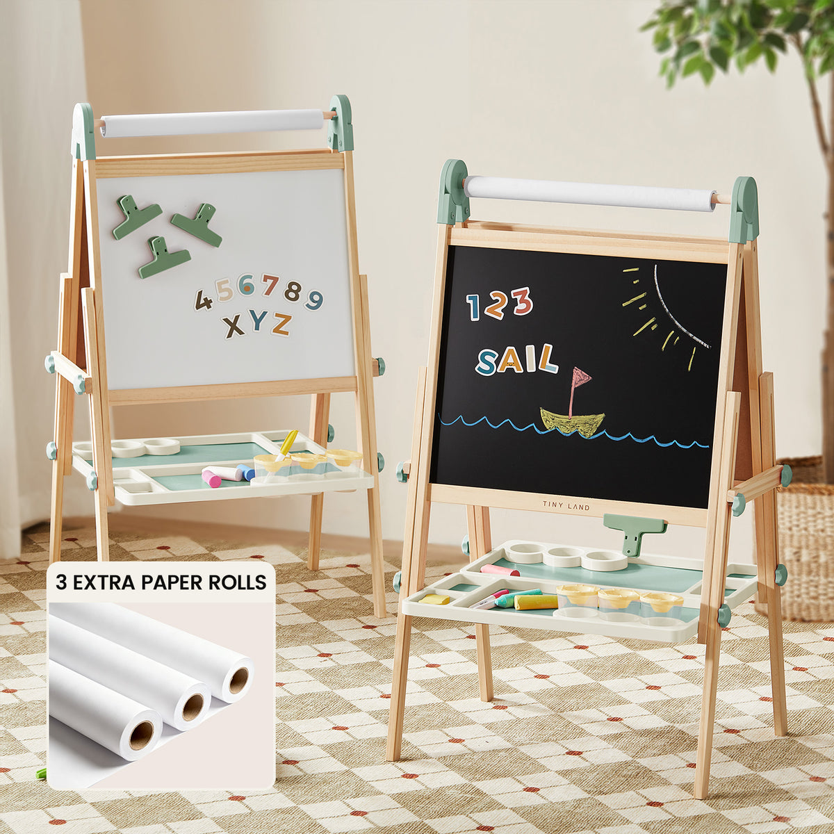 The Tiny Land® Green Magnitales Easel & Paper Roll Set by Tiny Land features a double-sided wooden easel with magnetic whiteboard, chalkboard with “SAIL” drawing, trays, and three extra paper rolls—perfect for kids’ indoor creativity.