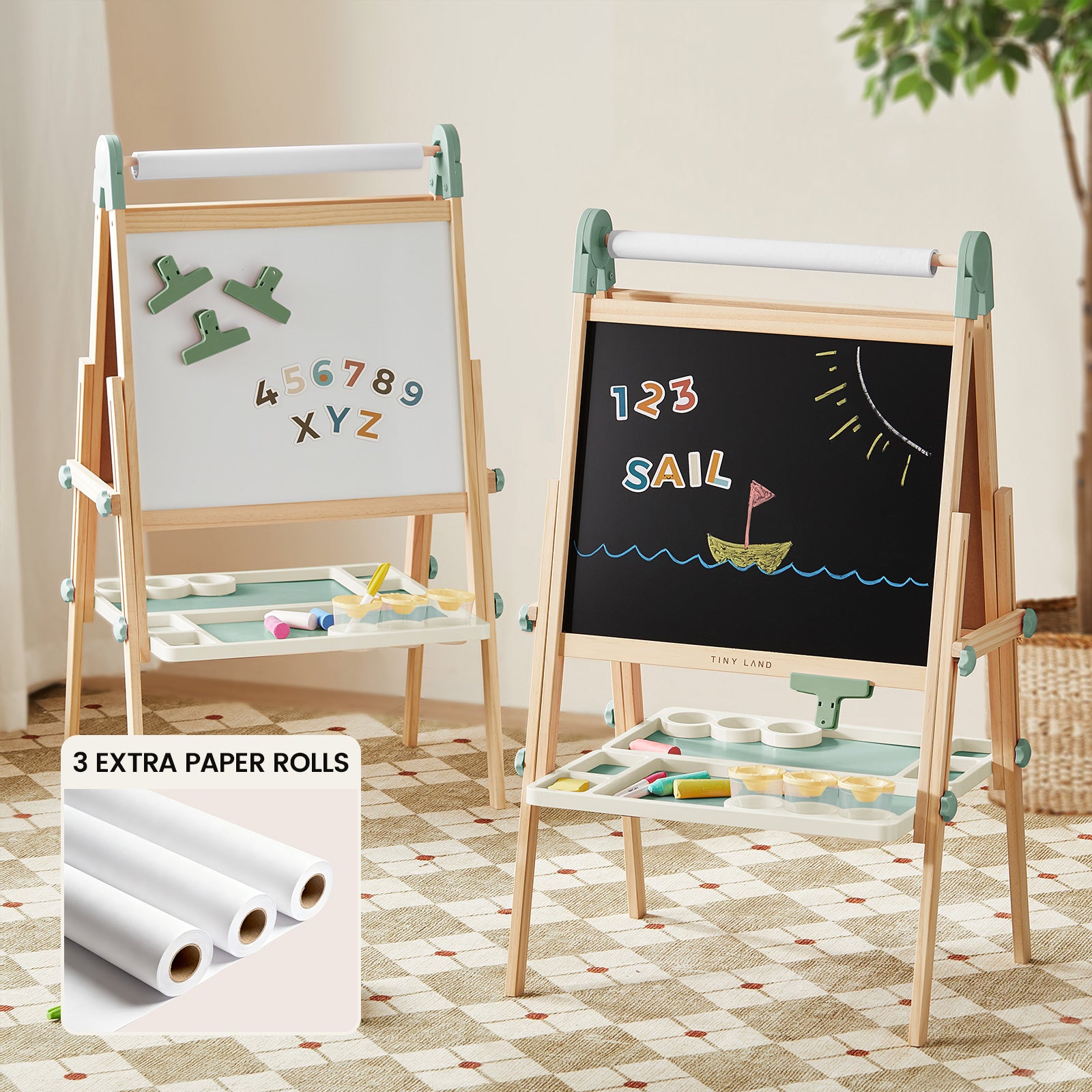 The Tiny Land® Green Magnitales Easel & Paper Roll Set by Tiny Land features a double-sided wooden easel with magnetic whiteboard, chalkboard with “SAIL” drawing, trays, and three extra paper rolls—perfect for kids’ indoor creativity.