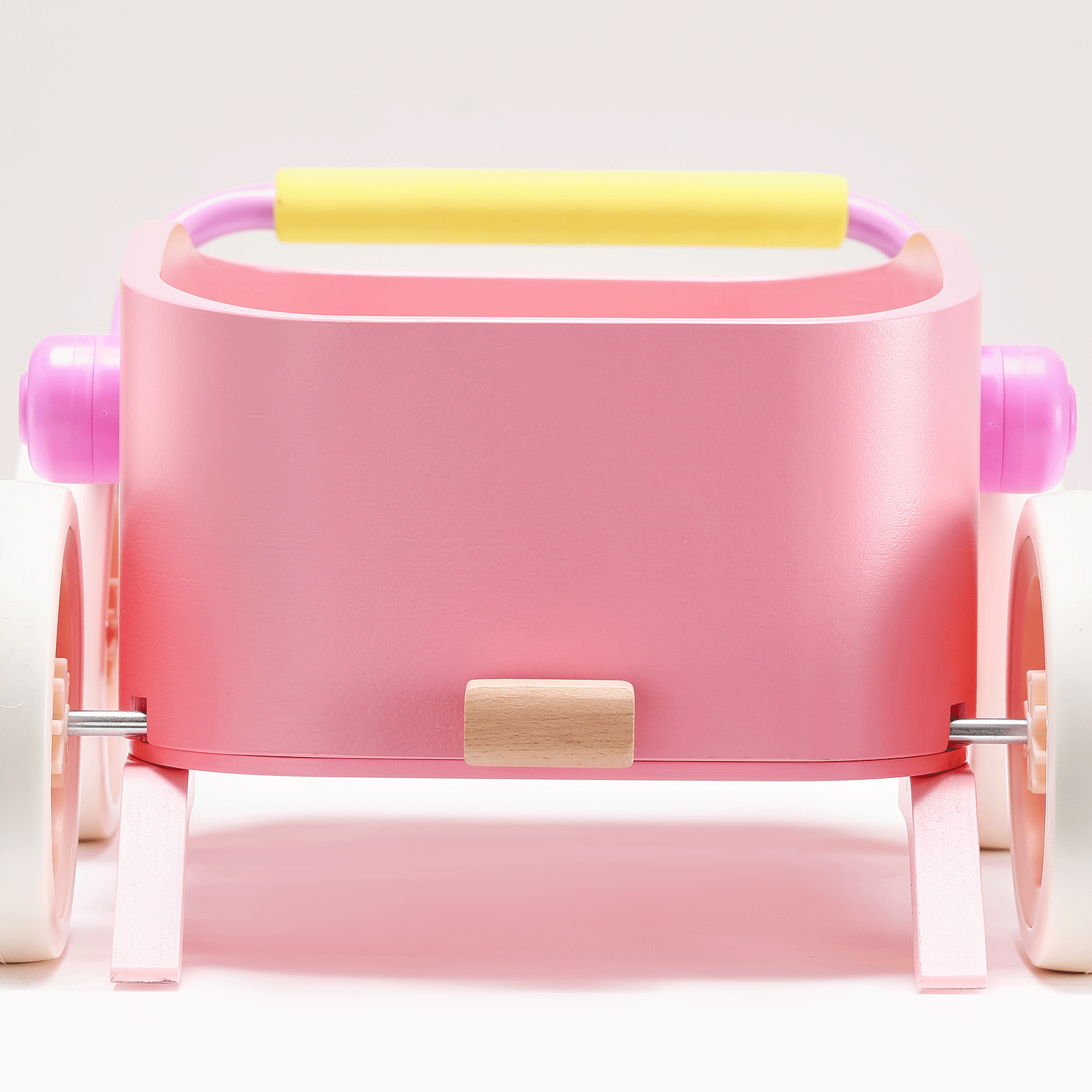 The Tiny Land® 3-in-1 Wooden Baby Walker Wagon - Pink by Tiny Land features a pink wooden frame, white wheels, yellow handle, and pink side accents, shown against a plain white background.