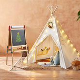 The Tiny Land Vibrant Imaginative Retreat Set features a kids teepee and colorful easel—perfect for playrooms. The indoor tent, paired with plush cushions and toys, creates a cozy, creative space where kids can relax and draw by the wreath-lit setup.