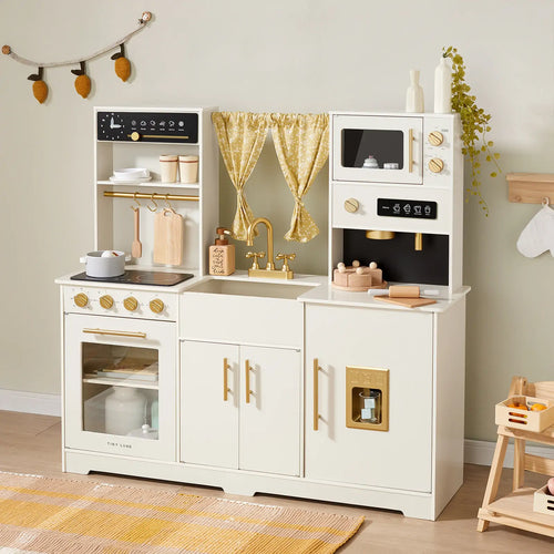 The Tiny Land® Iconic Wooden Play Kitchen – Cream Pretend Cooking Set for Kids features a stove, oven, sink, and microwave with gold accents, plus toy utensils, dishes, a pot, and curtains—perfect for imaginative play.