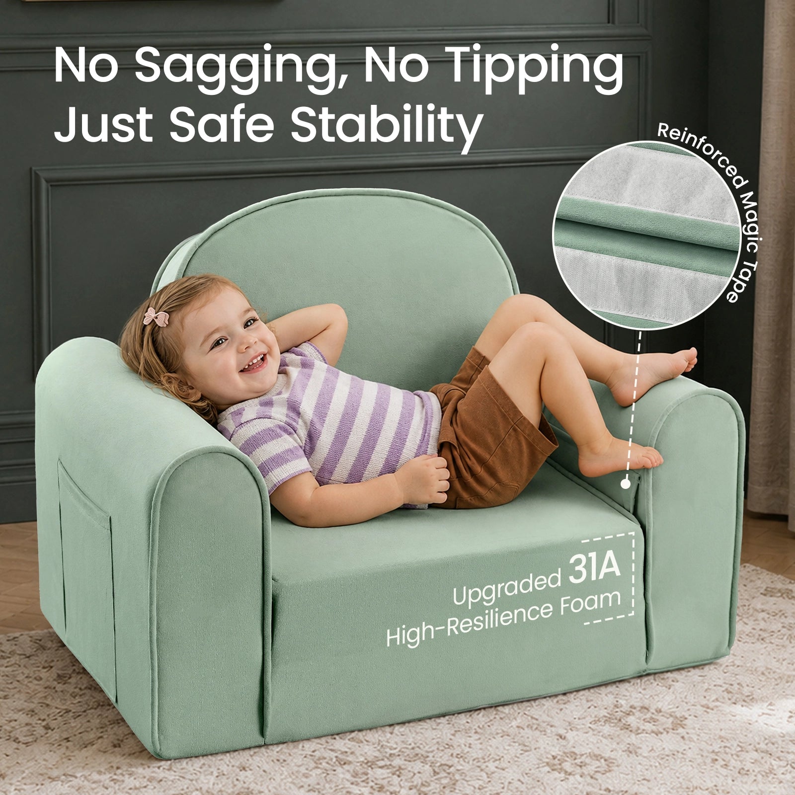 A smiling young child relaxes on the Tiny Land® GentleSnug Kids Sofa Chair, a light green toddler armchair by Tiny Land, featuring highlighted text about its stability, upgraded foam, and reinforced magic tape. The flip-open chair is set in a cozy room with dark walls and a beige rug.|Light Green