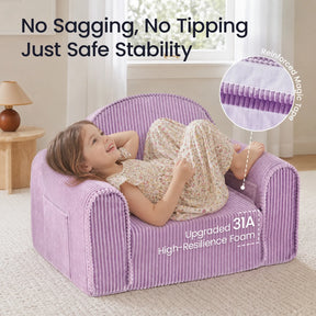 A young child in a floral dress lounges on the Tiny Land® GentleSnug Corduroy Kid Chair, an easy-to-clean purple chair from Tiny Land. Text highlights its sturdy design with magic tape reinforcement and upgraded 31A high-resilience foam for lasting comfort. A lamp and table are visible in the background.|Purple