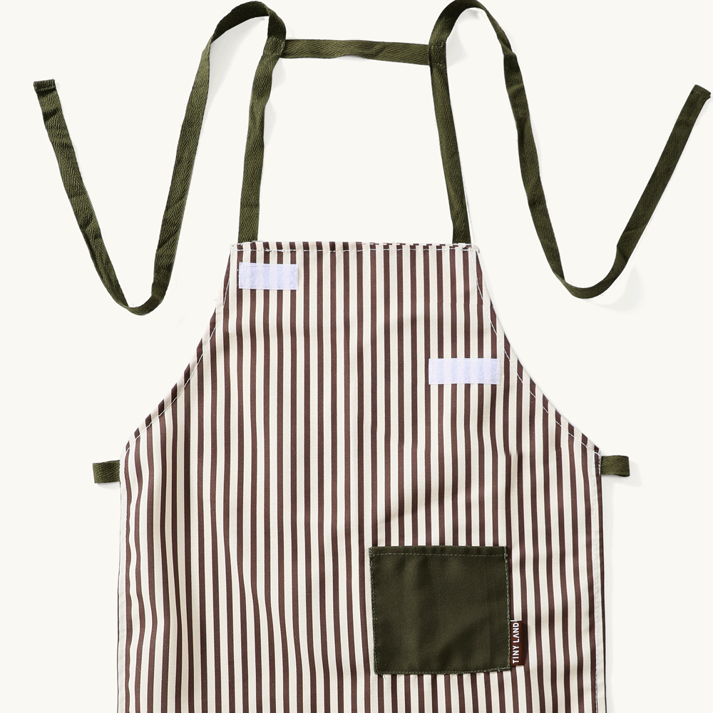 A striped apron with vertical brown and white lines, dark green ties, and a pocket—perfect for the Tiny Land® BistroSwitch Play Kitchen from Tiny Land.|White