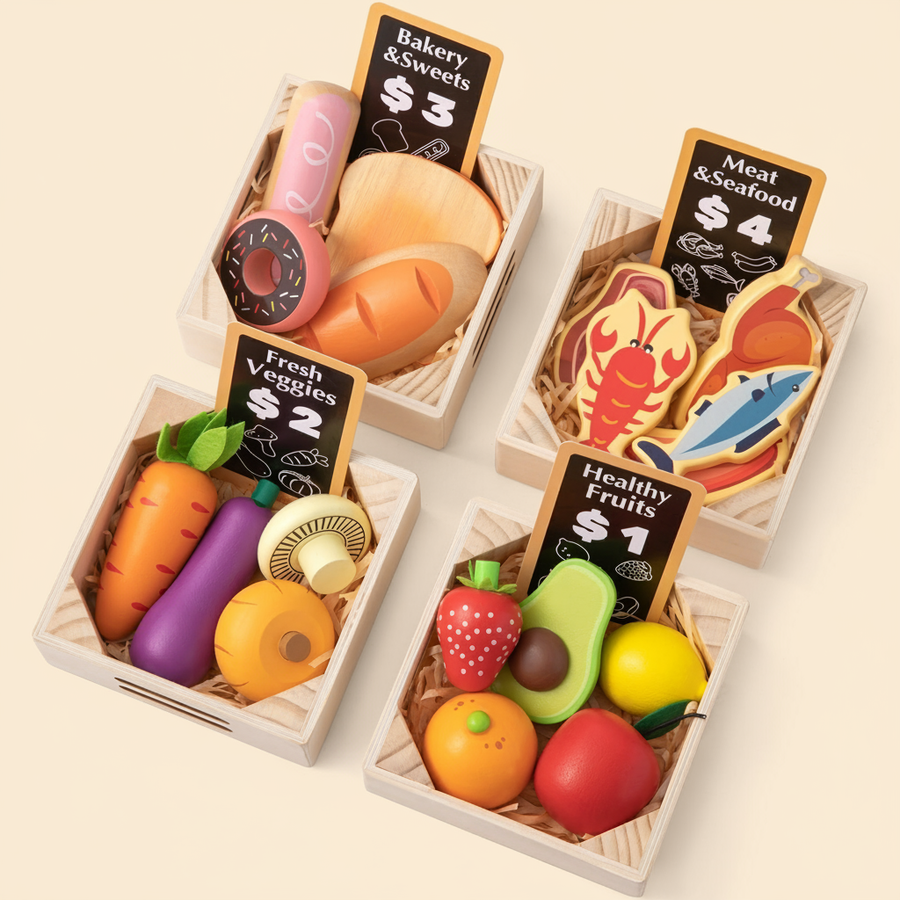 Four wooden crates from Tiny Land Play Food display bakery items ($3), meat & seafood ($4), veggies ($2), and fruits ($1). Each colorful, realistic play food set for toddlers features straw bedding—part of the Tiny Land® Play Kitchen Accessories.